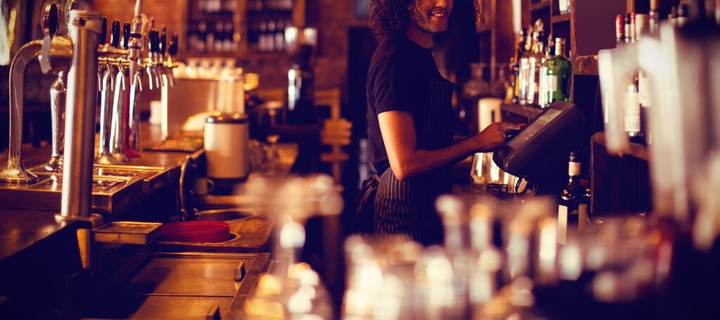 Pub bartender behind the bar